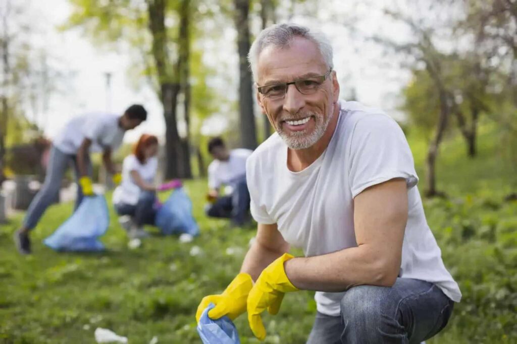old man smiling while cleaning the garden
