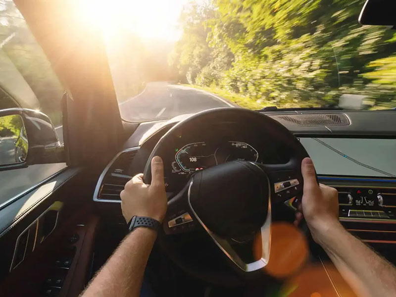 man driving a car on road