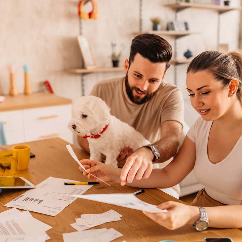 a couple and a dog with insurance papers