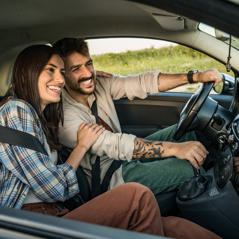 a couple driving a car