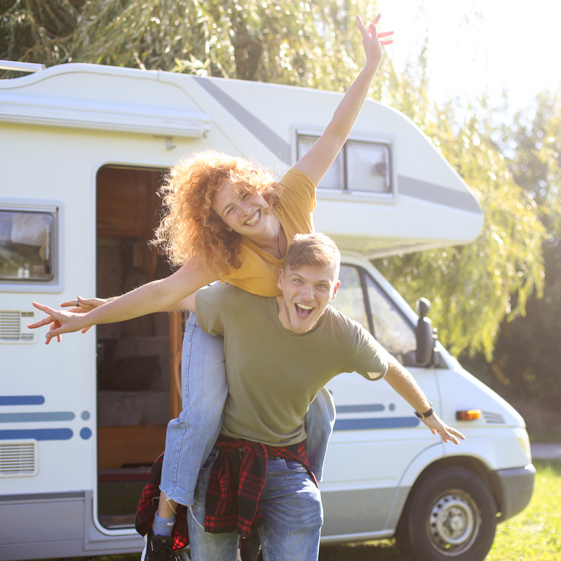 a happy couple and a mobile home