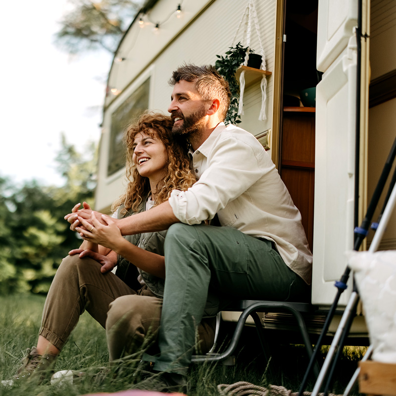 a happy couple and a mobile home